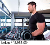 Dumbbell man at gym workout biceps fitness weightlifting. Стоковое фото, агентство Ingram Publishing / Фотобанк Лори