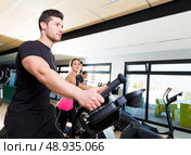 Aerobics elliptical walker trainer group at fitness gym workout. Стоковое фото, агентство Ingram Publishing / Фотобанк Лори
