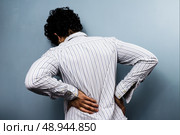 Young man with a sore back. Стоковое фото, агентство Ingram Publishing / Фотобанк Лори