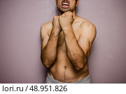 Athletic young man with his fists raised. Стоковое фото, агентство Ingram Publishing / Фотобанк Лори