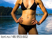 Young woman in swimwear standing in a mountain lake. Стоковое фото, агентство Ingram Publishing / Фотобанк Лори