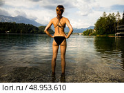Young woman in swimwear standing in a mountain lake. Стоковое фото, агентство Ingram Publishing / Фотобанк Лори