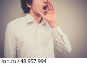 Young man is shouting an announcement. Стоковое фото, агентство Ingram Publishing / Фотобанк Лори