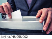 A Businessman is shredding important documents. Стоковое фото, агентство Ingram Publishing / Фотобанк Лори