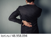 Young businessman with a sore neck and back. Стоковое фото, агентство Ingram Publishing / Фотобанк Лори