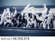 Close up on a cross shredder with paper. Стоковое фото, агентство Ingram Publishing / Фотобанк Лори
