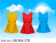 Set of colored dresses hanging on a clothesline on a sunny day. Vector illustration. Стоковая иллюстрация, агентство Ingram Publishing / Фотобанк Лори