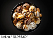 A bowl of ice cream with nuts and caramel sauce. Стоковое AI-изображение, AI-художник Ярославский Максим / Фотобанк Лори