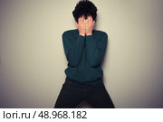 Young man is hiding his face in the palms of his hands. Стоковое фото, агентство Ingram Publishing / Фотобанк Лори