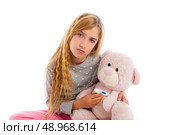 blond girl with teddy bear thermometer and flu cold in pyjama. Стоковое фото, агентство Ingram Publishing / Фотобанк Лори