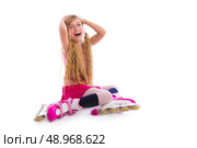 blond pigtails roller skate girl sitting laughing happy on white background. Стоковое фото, агентство Ingram Publishing / Фотобанк Лори