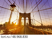 Brooklyn Bridge sunset New York Manhattan skyline NY NYC USA. Стоковое фото, агентство Ingram Publishing / Фотобанк Лори