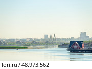 Picturesque view of the river Kazanka, a coastal house and a cable-stayed bridge Millennium Bridge. Russia (2022 год). Стоковое фото, фотограф Константин Лабунский / Фотобанк Лори