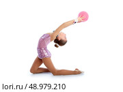 Kid girl ball rhythmic gymnastics exercise on white background. Стоковое фото, агентство Ingram Publishing / Фотобанк Лори