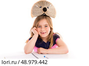 Blond kid girl student with hedgehog book on white background. Стоковое фото, агентство Ingram Publishing / Фотобанк Лори
