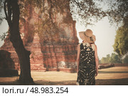 A young woman is exploring the ancient ruins of a buddhist temple city. Стоковое фото, агентство Ingram Publishing / Фотобанк Лори