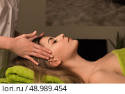 Young woman having a facial massage at the spa. Стоковое фото, агентство Ingram Publishing / Фотобанк Лори