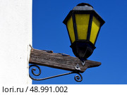 a street lamp and a wall in calle de los suspiros in colonia del sacramento uruguay. Стоковое фото, агентство Ingram Publishing / Фотобанк Лори