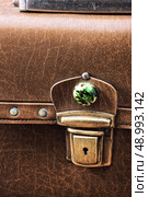 old-fashioned suitcase in yellow leather with metal latch. obsolete bag. Стоковое фото, агентство Ingram Publishing / Фотобанк Лори