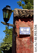 a street lamp plate plant and a wall in calle de los suspiros of house in colonia del sacramento  uruguay. Стоковое фото, агентство Ingram Publishing / Фотобанк Лори