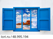 Almeria view from blue window of Mojacar beach photo mount. Стоковое фото, агентство Ingram Publishing / Фотобанк Лори