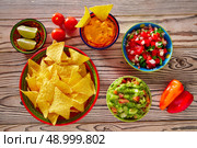 Mexican food mixed guacamole nachos chili sauce dipping cheddar cheese lemon pico de gallo. Стоковое фото, агентство Ingram Publishing / Фотобанк Лори
