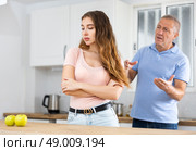 Elderly indignant father scolding adult daughter in kitchen. Стоковое фото, фотограф Яков Филимонов / Фотобанк Лори