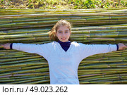 Kid girl relaxed in green canes background in autumn winter. Стоковое фото, агентство Ingram Publishing / Фотобанк Лори