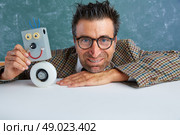 Nerd electronics technician with self made robot silly retro teacher. Стоковое фото, агентство Ingram Publishing / Фотобанк Лори