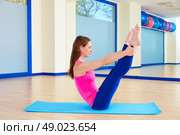 Pilates woman open leg rocker exercise workout at gym indoor. Стоковое фото, агентство Ingram Publishing / Фотобанк Лори
