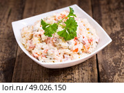bowl of traditional russian salad on wooden table. Стоковое фото, агентство Ingram Publishing / Фотобанк Лори