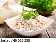 bowl of traditional russian salad on wooden table. Стоковое фото, агентство Ingram Publishing / Фотобанк Лори