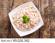 bowl of traditional russian salad on wooden table. Стоковое фото, агентство Ingram Publishing / Фотобанк Лори