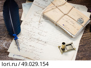 feather pen .  pile of  antique letters and blue  feather pen. Стоковое фото, агентство Ingram Publishing / Фотобанк Лори
