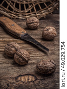 walnut. few walnuts on wooden background from autumn harvest. Стоковое фото, агентство Ingram Publishing / Фотобанк Лори
