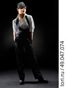 Young girl in manly style on black. Стоковое фото, агентство Ingram Publishing / Фотобанк Лори