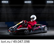 Young girl karting racer at stadium. Стоковое фото, агентство Ingram Publishing / Фотобанк Лори