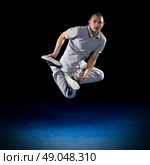 Breakdancer training on dark background. Стоковое фото, агентство Ingram Publishing / Фотобанк Лори