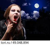 Vampire woman on night background with moon. Стоковое фото, агентство Ingram Publishing / Фотобанк Лори