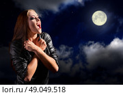 Vampire girl on night sky with moon. Стоковое фото, агентство Ingram Publishing / Фотобанк Лори