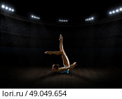 Young girl engaged art gymnastic at sports hall. Стоковое фото, агентство Ingram Publishing / Фотобанк Лори