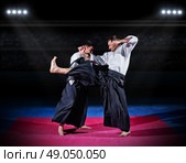 Two aikido fighters at sports hall. Стоковое фото, агентство Ingram Publishing / Фотобанк Лори