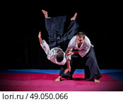 Fight between two aikido fighters on black. Стоковое фото, агентство Ingram Publishing / Фотобанк Лори