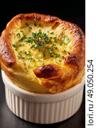 Delicious Cheese Souffl Baked to Perfection With Fresh Herbs in a Ramekin. Стоковое AI-изображение, AI-художник Юлия Гапеенко / Фотобанк Лори