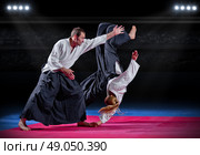 Two aikido fighters at sports hall. Стоковое фото, агентство Ingram Publishing / Фотобанк Лори