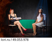 Angel and devil at dark room. Стоковое фото, агентство Ingram Publishing / Фотобанк Лори