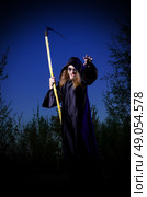 Zombie girl with scythe in night forest. Стоковое фото, агентство Ingram Publishing / Фотобанк Лори