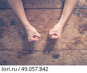 Female fists clenched on a wooden table in anger. Стоковое фото, агентство Ingram Publishing / Фотобанк Лори