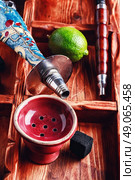 Accessories for Shisha. Dismantled parts of hookah on a wooden background with lime fruit. Стоковое фото, агентство Ingram Publishing / Фотобанк Лори