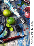 Accessories for Shisha. Dismantled parts of hookah on a wooden background with lime fruit. Стоковое фото, агентство Ingram Publishing / Фотобанк Лори
